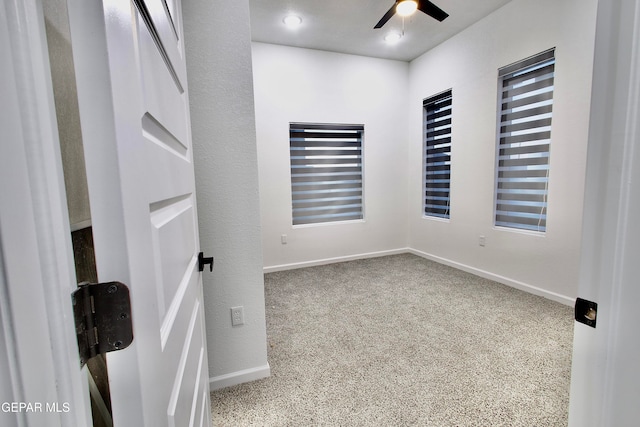 carpeted empty room with ceiling fan