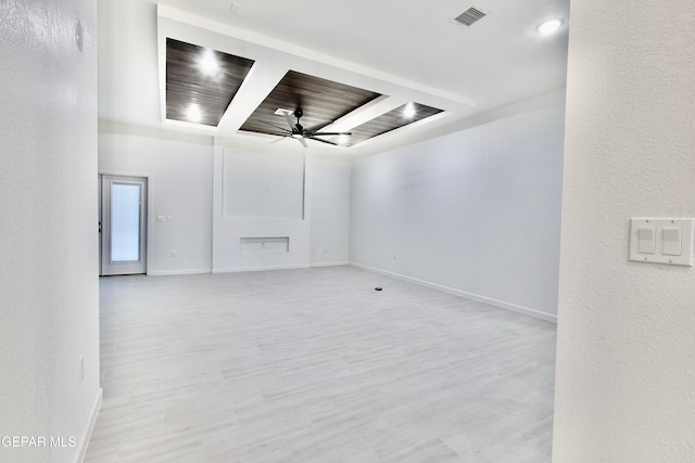 spare room with light wood-type flooring, ceiling fan, and wooden ceiling