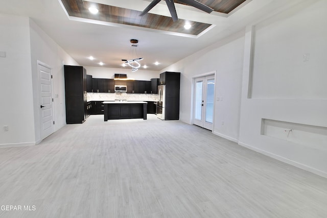 kitchen with light wood-type flooring, a center island, hanging light fixtures, and ceiling fan