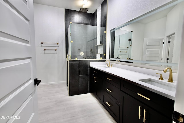 bathroom featuring vanity, an enclosed shower, and hardwood / wood-style flooring