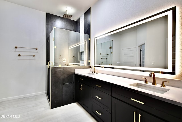 bathroom featuring vanity, wood-type flooring, and walk in shower