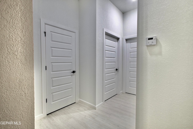 hall with light hardwood / wood-style flooring