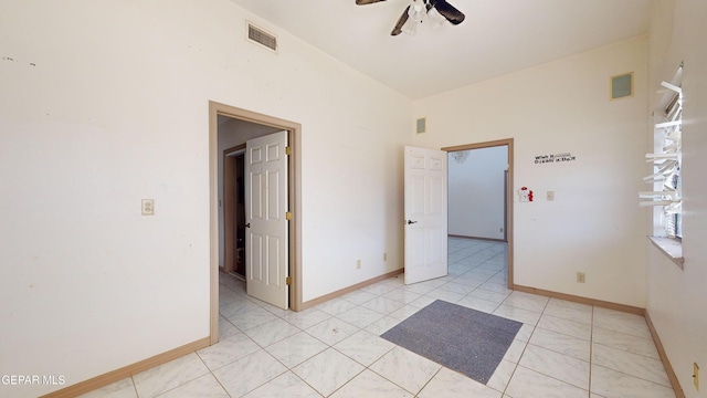 tiled spare room with ceiling fan