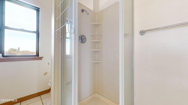 bathroom featuring tile patterned flooring and an enclosed shower