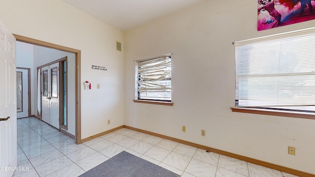 unfurnished room featuring light tile patterned floors