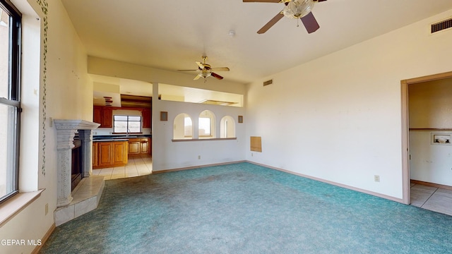 unfurnished living room with plenty of natural light and light carpet