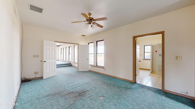 empty room with light colored carpet and ceiling fan