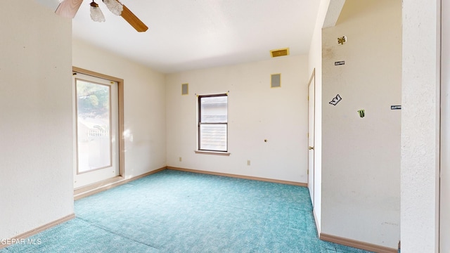 unfurnished room featuring light carpet, a wealth of natural light, and ceiling fan