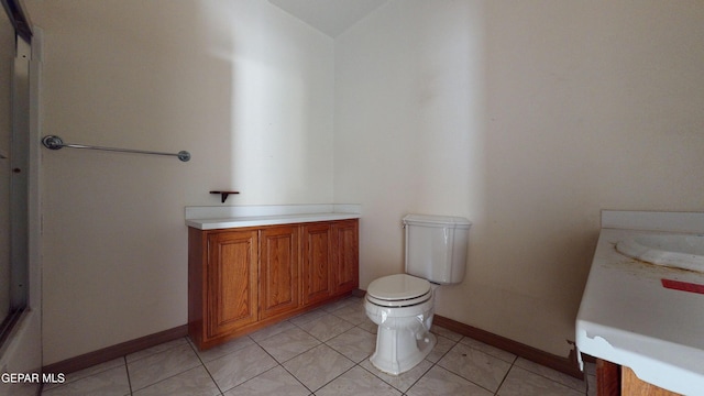 bathroom featuring tile patterned flooring, vanity, and toilet