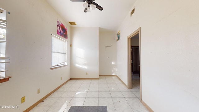 empty room featuring ceiling fan and light tile patterned flooring