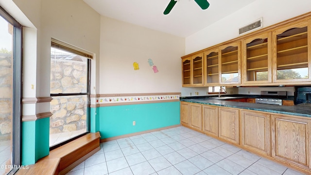 kitchen featuring ceiling fan, a healthy amount of sunlight, light tile patterned flooring, and sink