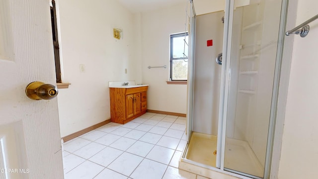 bathroom featuring tile patterned flooring, vanity, and an enclosed shower