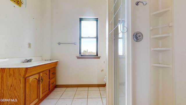 bathroom featuring a shower, tile patterned flooring, vanity, and toilet