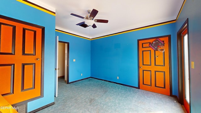 unfurnished bedroom with ceiling fan, crown molding, and light carpet