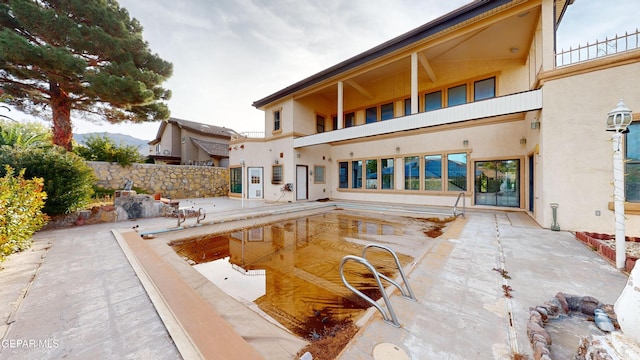 exterior space featuring a patio and a balcony