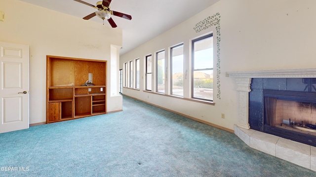 unfurnished living room featuring carpet flooring, ceiling fan, and a fireplace