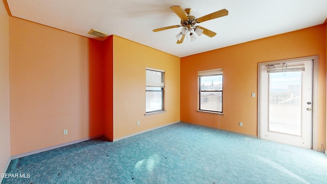 spare room featuring ceiling fan and carpet floors