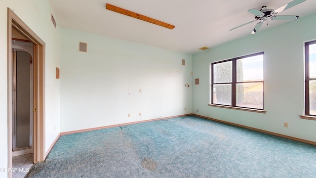 carpeted empty room featuring ceiling fan