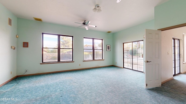 carpeted spare room with ceiling fan