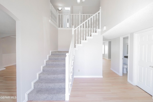 staircase with wood-type flooring