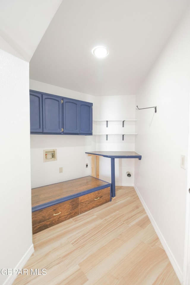 clothes washing area featuring hookup for an electric dryer, hookup for a washing machine, cabinets, and light hardwood / wood-style flooring