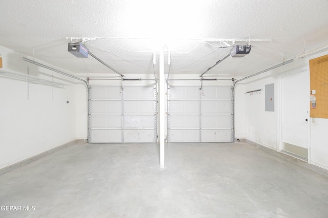 garage with electric panel and a garage door opener