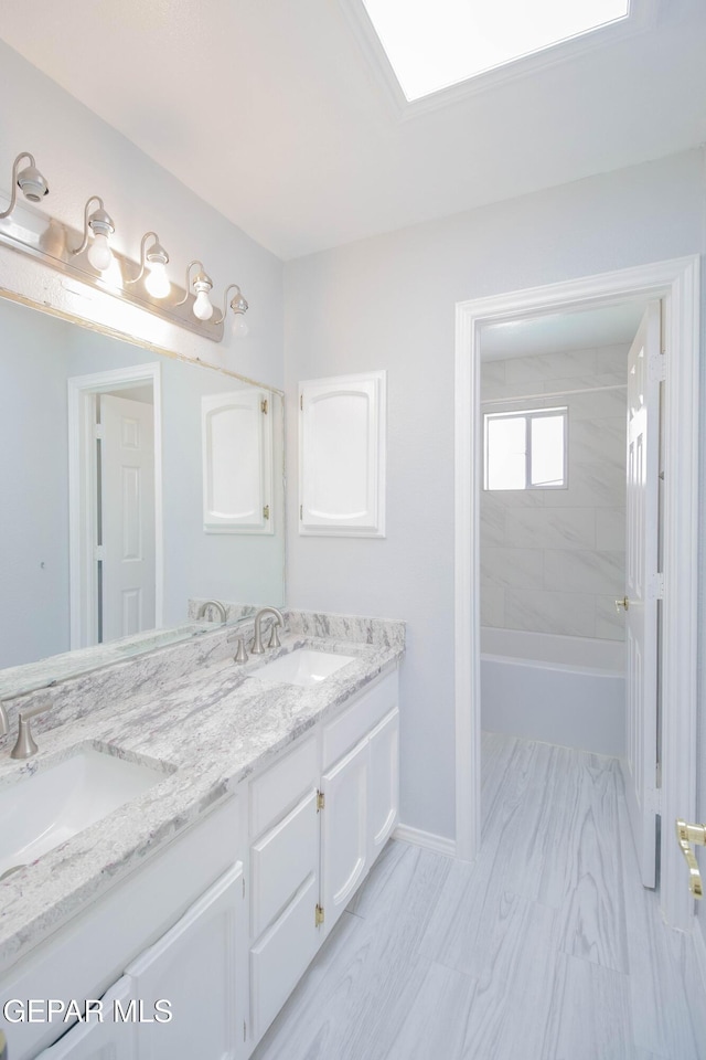 bathroom featuring vanity and tiled shower / bath combo