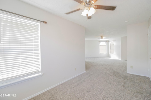 carpeted empty room with ceiling fan