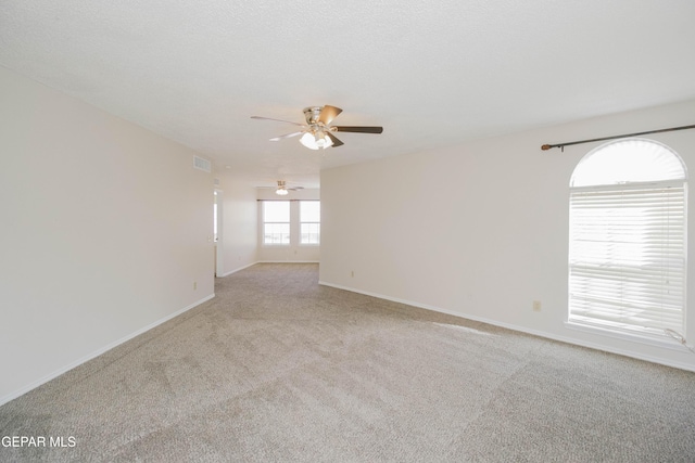 empty room featuring light carpet and ceiling fan