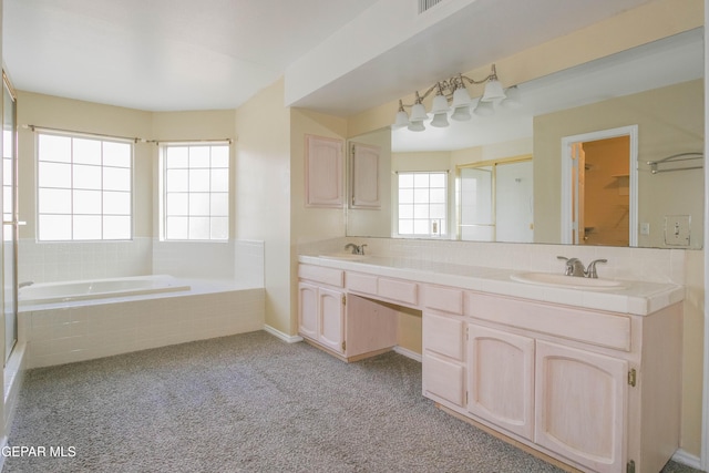 bathroom with plenty of natural light, vanity, and shower with separate bathtub