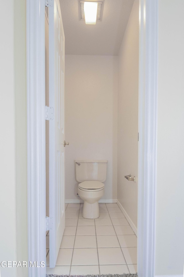 bathroom featuring tile patterned floors and toilet