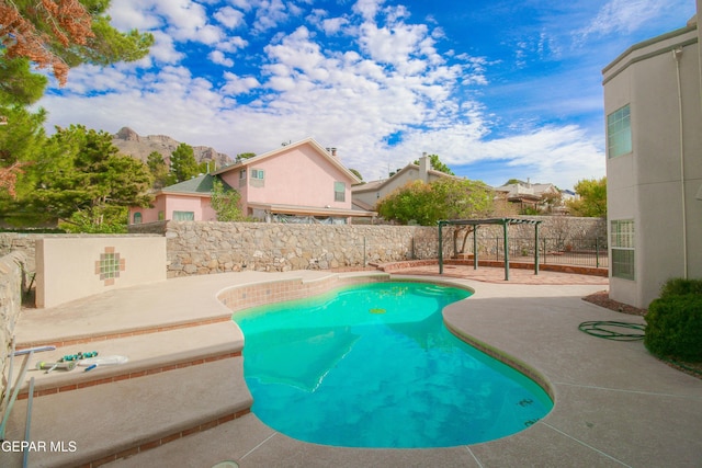 view of swimming pool featuring a mountain view and a patio