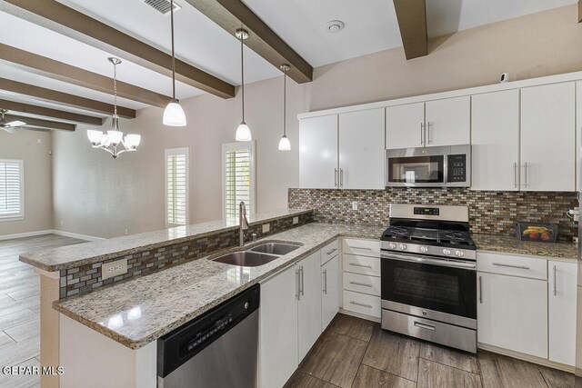 kitchen featuring stainless steel appliances, sink, beam ceiling, white cabinets, and hanging light fixtures