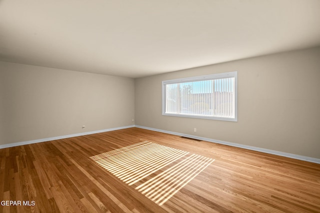 unfurnished room with light hardwood / wood-style flooring