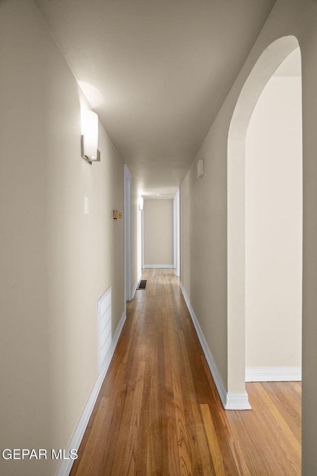 hall with hardwood / wood-style flooring