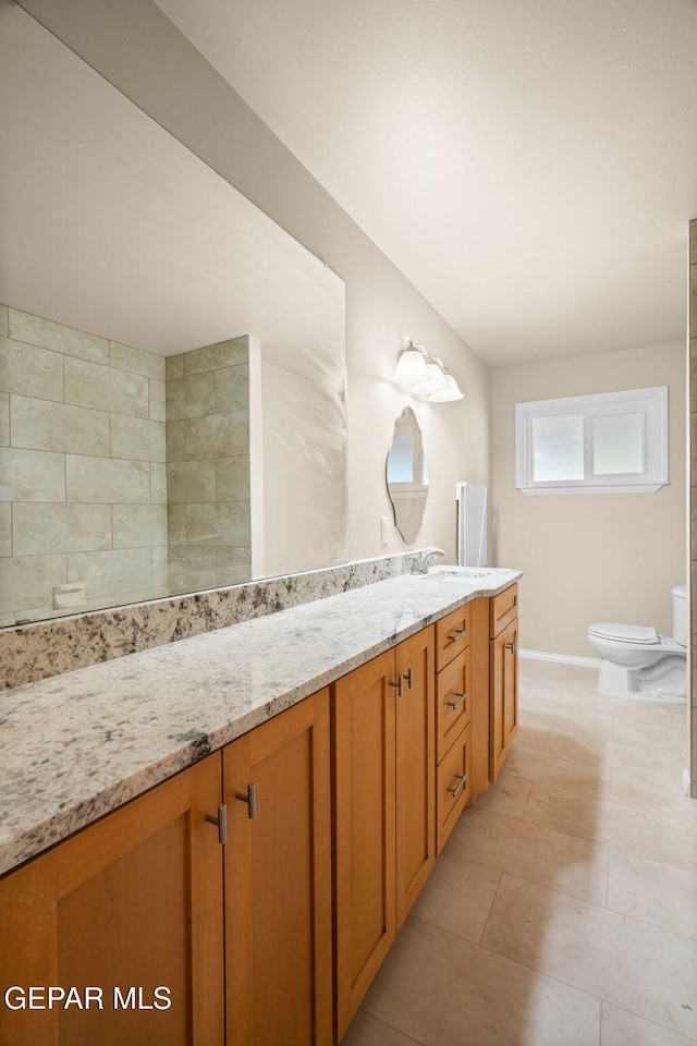 bathroom featuring tile patterned flooring, vanity, and toilet