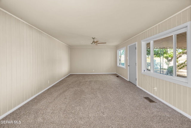 unfurnished room with carpet floors, ceiling fan, and ornamental molding