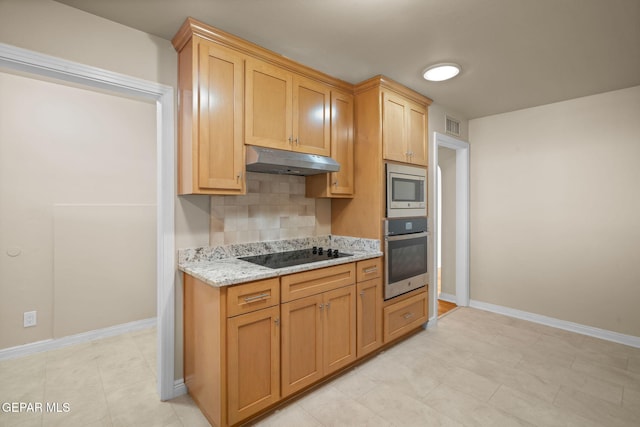 kitchen with decorative backsplash, light stone countertops, light tile patterned floors, and stainless steel appliances