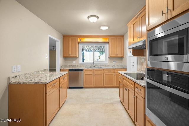 kitchen with light stone countertops, sink, light tile patterned flooring, and stainless steel appliances