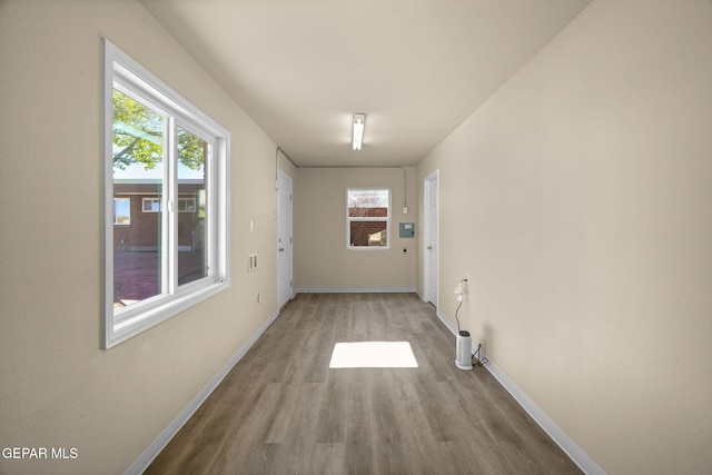 hallway with light hardwood / wood-style flooring