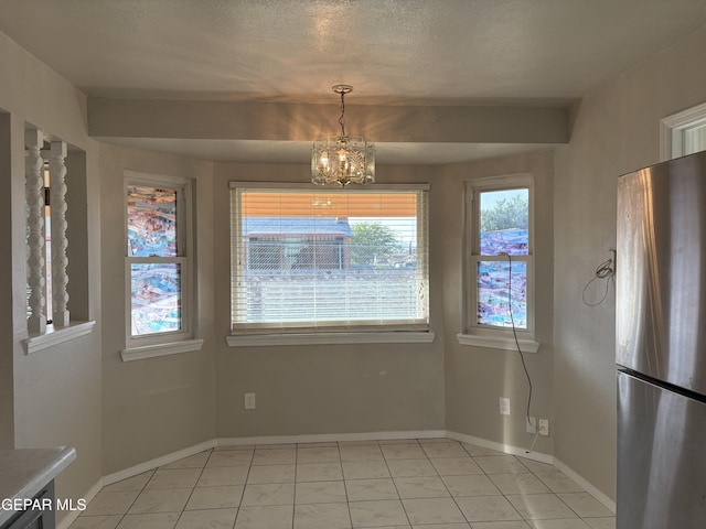 2149 Octubre Dr, El Paso, TX 79935 - unfurnished dining area featuring baseboards and a notable chandelier