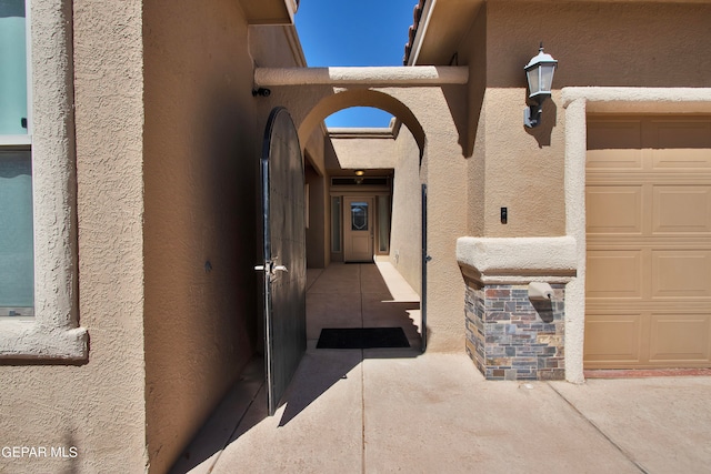 doorway to property with a garage