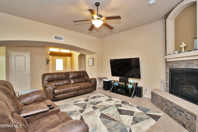 tiled living room with ceiling fan