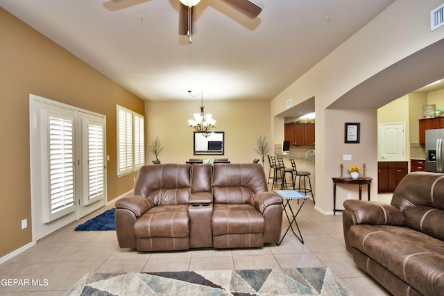 living room with ceiling fan with notable chandelier and light tile patterned flooring