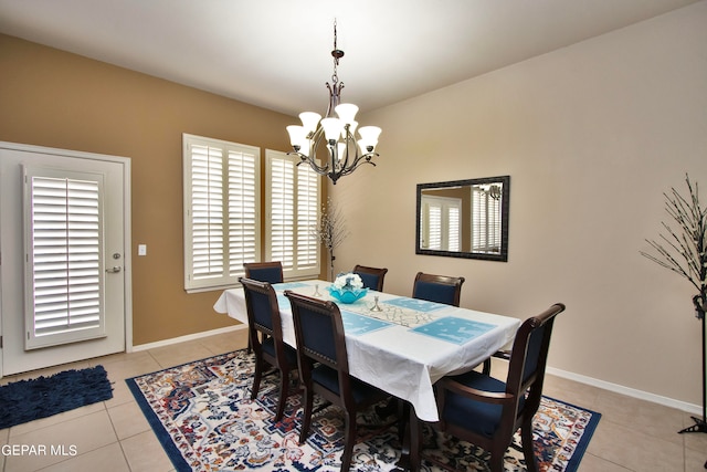 dining space featuring light tile patterned floors and an inviting chandelier