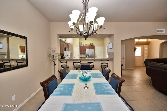 dining area with a notable chandelier and light tile patterned floors