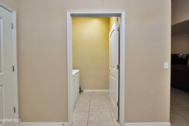 bathroom with washing machine and dryer and tile patterned floors