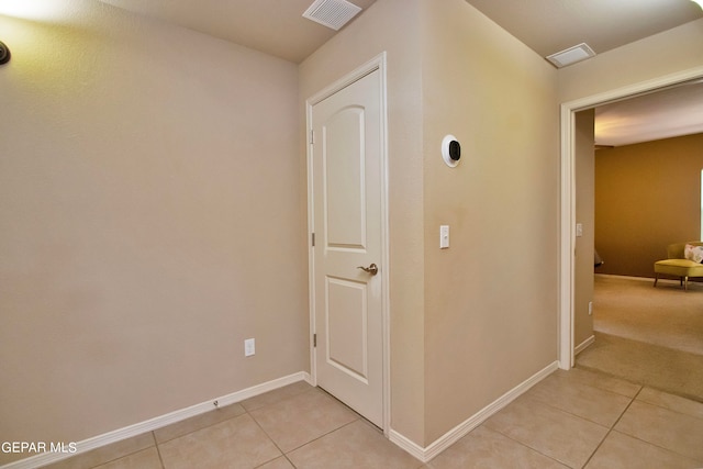 corridor featuring light tile patterned floors