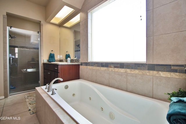 bathroom featuring tile patterned floors, separate shower and tub, and vanity