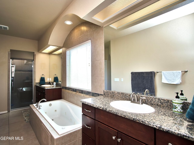 bathroom with tile patterned floors, vanity, and separate shower and tub